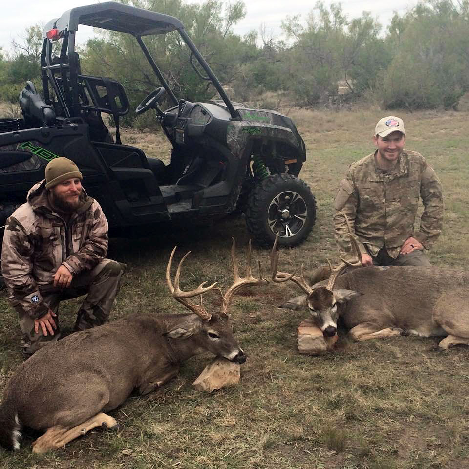 two happy hunter posing with game