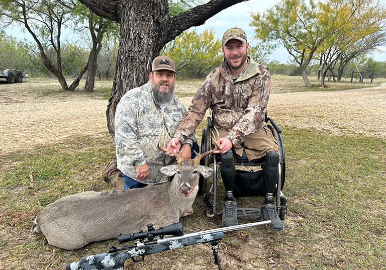 two smiling vets with successful deer hunt