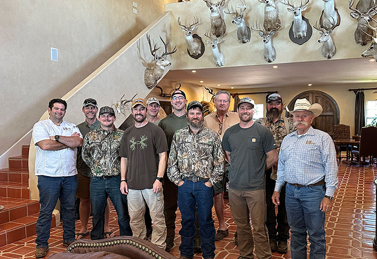 rancher and veterans inside lodge with deer mounted
