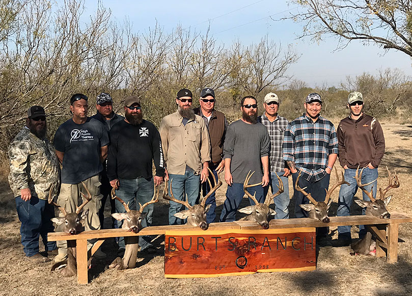veterans group outdoor hunt with six deer head